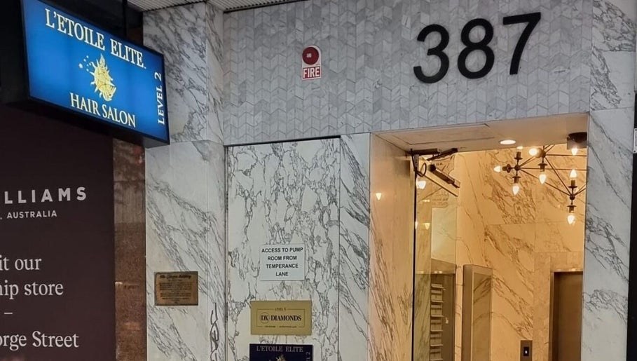 The street entrance at 387 George Street, with the blue L’Etoile Elite sign